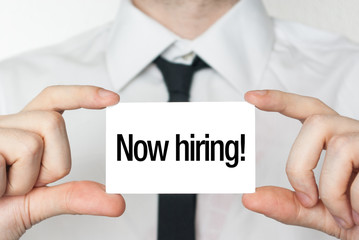 Now hiring advertisement. Businessman in white shirt with a blac