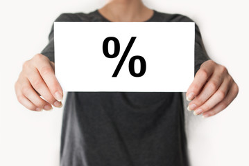 Percent sign for interest. Female in black shirt showing or hold