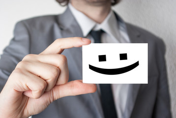 Smile happy face. Businessman in suit with a black tie showing o