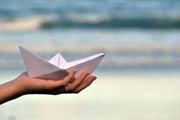 Paper boat on beach