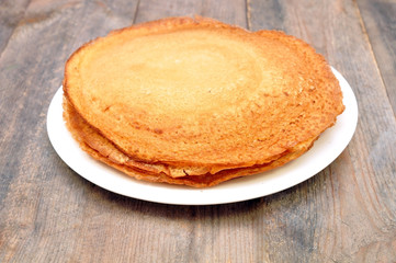 pancakes on a plate on a wooden table