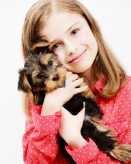 Young girl with  puppy, cute Yorkshire terrier