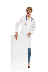 Female doctor pointing at banner.