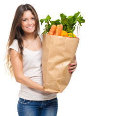 Smiling woman holding a bag full of vegetables