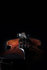 Fototapeta premium Old violin on dark background. Closeup view.