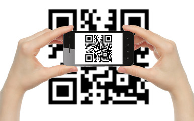 Hands hold smart phone with QR code on white background .