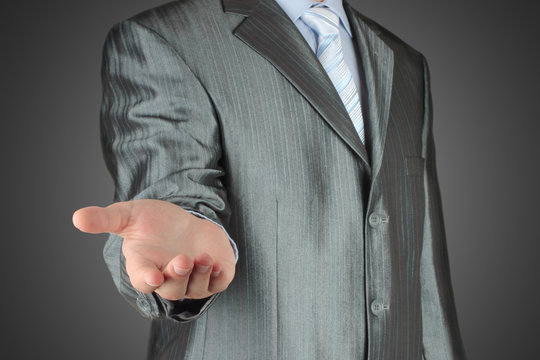 Man with stratched hand on dark background.
