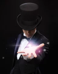 Fotobehang magician holding something on palm of his hand © Syda Productions