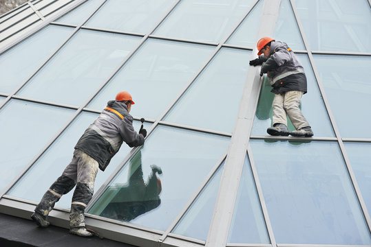 two workers installing outside window