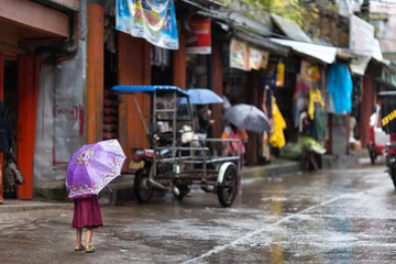 Little girl in the rain on a Philippines street - 62144688