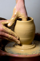 hands of a potter, creating an earthen jar