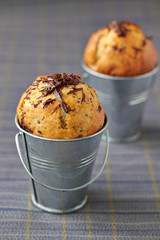 Banana muffins with chocolate in metal pails