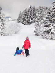 Fototapeta na wymiar small children in snow with sledges