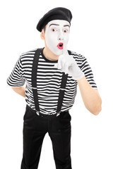 Male comedian holding finger on lips
