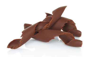 Chocolate shavings on white background .