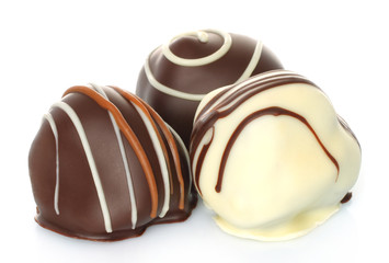 Assorted chocolate candies on white background .