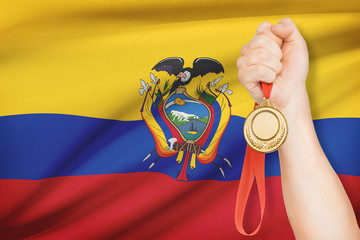 Medal in hand with flag on background - Republic of Ecuador