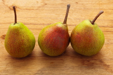 Three pears fruits on wooden table background