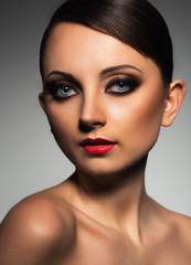 Portrait of a beautiful woman with a glamorous retro makeup