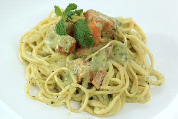 Spaghetti and salmon in pesto sauce