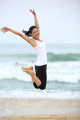 cheering woman jump at beach