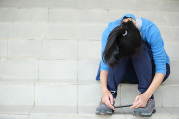 sad woman college student hold cellphone sit on stairs 