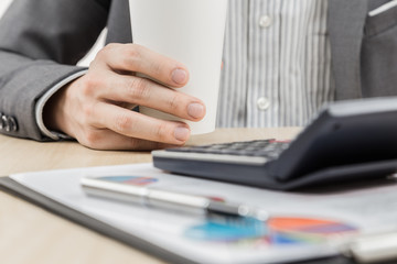 Businessman's hand showing financial report