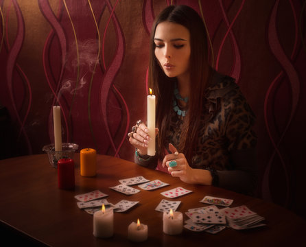girl extinguishes candles after divination
