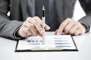 business report and man hand with pen