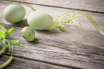 green easter eggs on wooden background