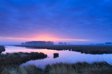 Purple, spring sunrise at a river.