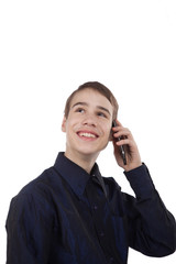 teenage boy having fun talking on the phone on white background
