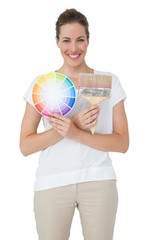 Portrait of a woman with paint samples and paintbrush