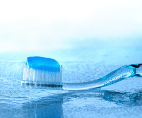 toothbrush with paste on wet glass