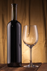 wine bottle and glass on wooden table