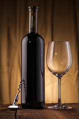 Wine bottle with glass on wooden table