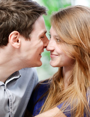 Fototapeta premium Very attractive young couple flirting on a sofa