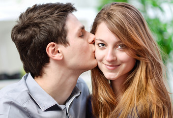 Fototapeta premium Handsome young man embracing his girlfriend with love