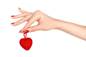 Beautiful hand with red manicure holding red heart.