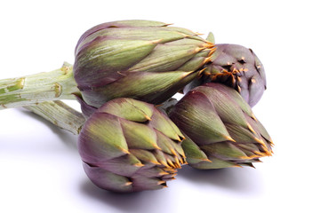 Raw spiny artichokes isolated on white background