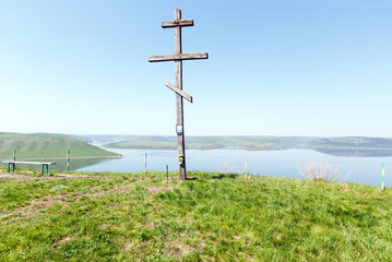 Obraz premium Wooden Cross and Bakota spring view (Ukraine)