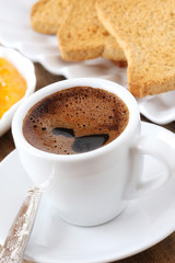 Breakfast concept - cup of black coffee with toasts and jam