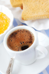 Breakfast concept - cup of black coffee with toasts and jam