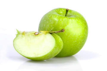 Green apple with a slice on white background