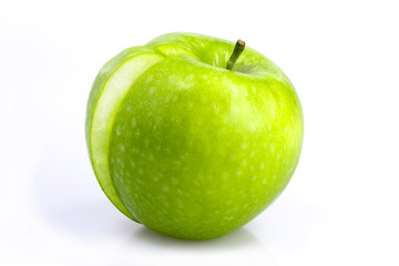 Green apple with a slice taken out on a white background