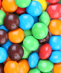 Background of chocolate balls in colorful glaze.
