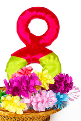 Colored paper flowers in the basket with symbol from 8 of March