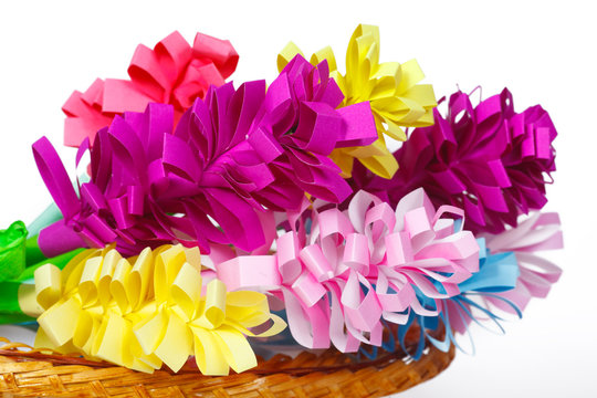 Many colored paper flowers in the basket