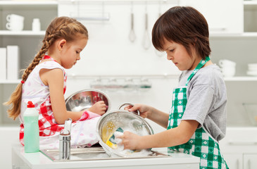 Grumpy kids doing home chores - washing dishes