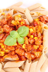 Whole grain Penne with sauce decorated with basil